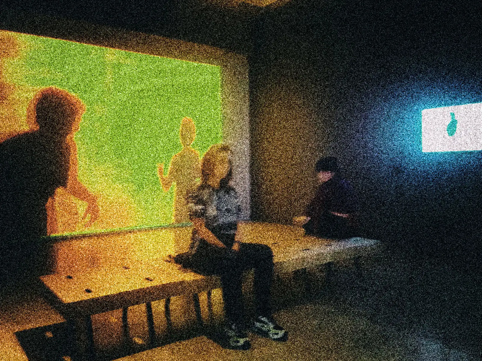 Diana López seated in a space with projected images