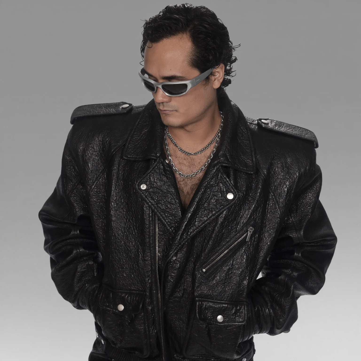 Portrait of Alejandro Molinari in a black leather jacket and silver sunglasses