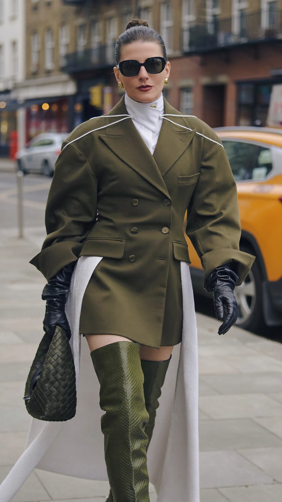 Julia Payne wearing sunglasses and an olive coat