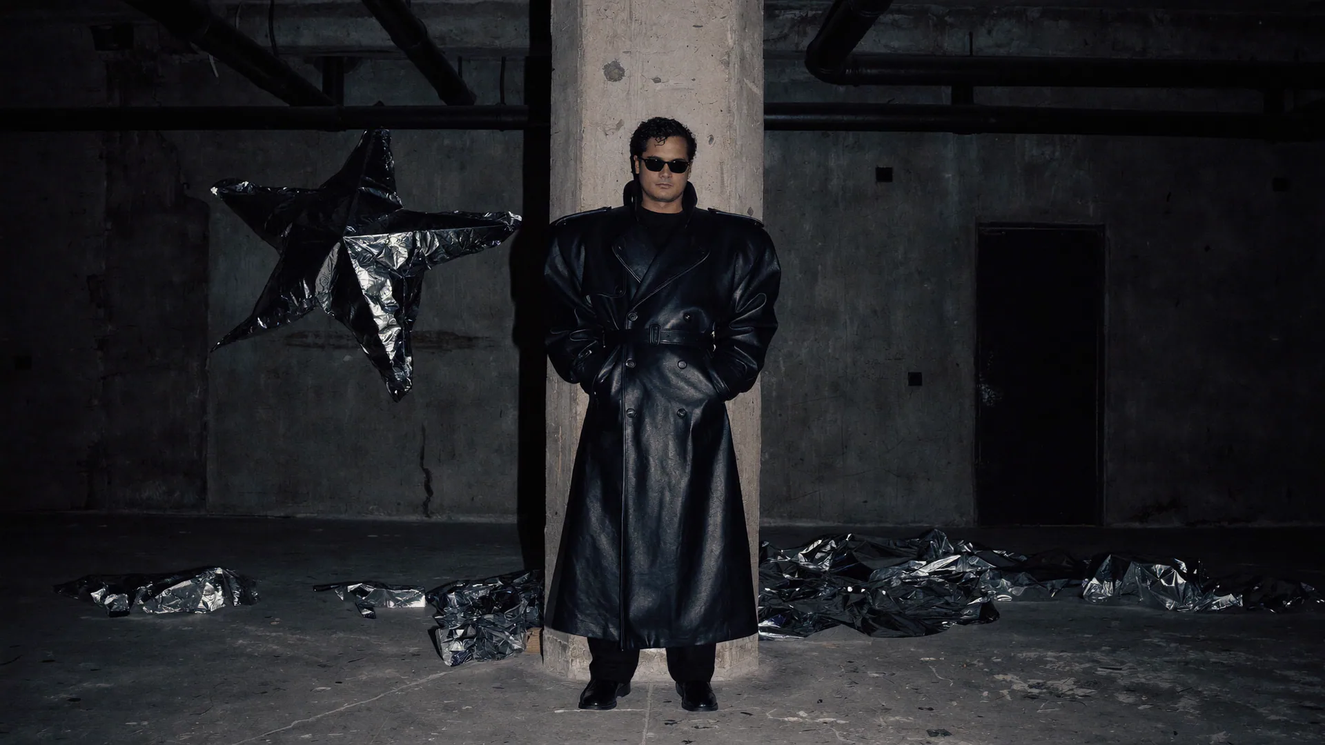 Alejandro Molinari wearing Lotus 2063 beside a reflective sculpture