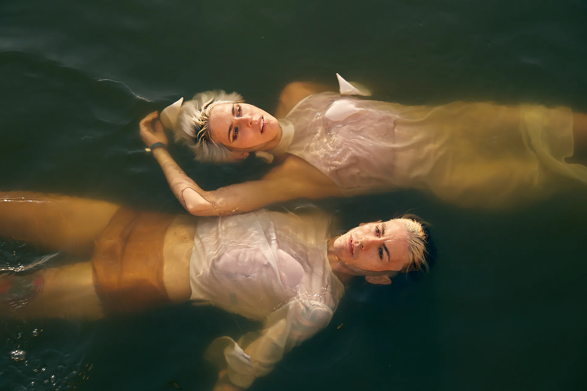 Awake Dreaming floating together in a suspended water scene