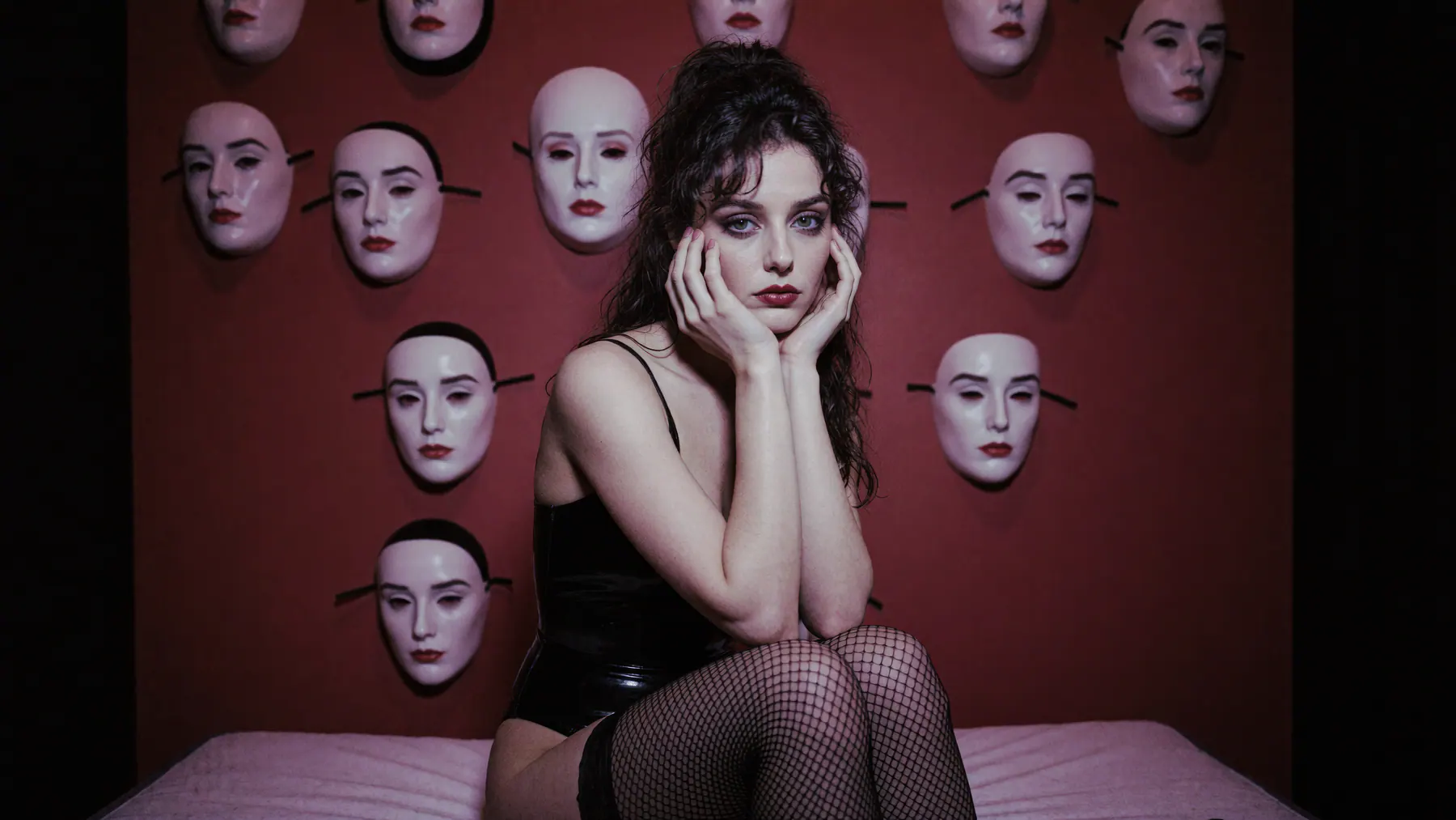 Nina FOK surrounded by reflected masks and black body material.